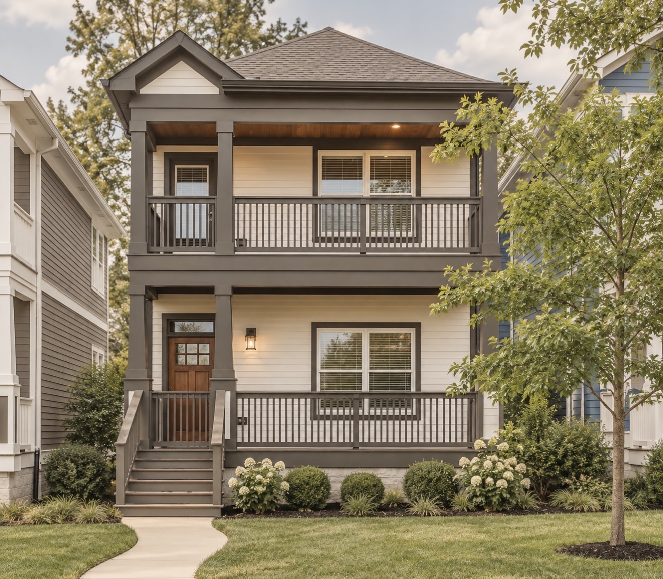 Two-story craftsman-style home with double porches, brown trim and a curved walkway beside neighboring homes
